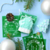 Целофановий пакетик «We wish a Merry Christmas/Різдвяний вінок» із зеленою підкладкою та з клейкою стрічкою, 10*10 cм + 3 см